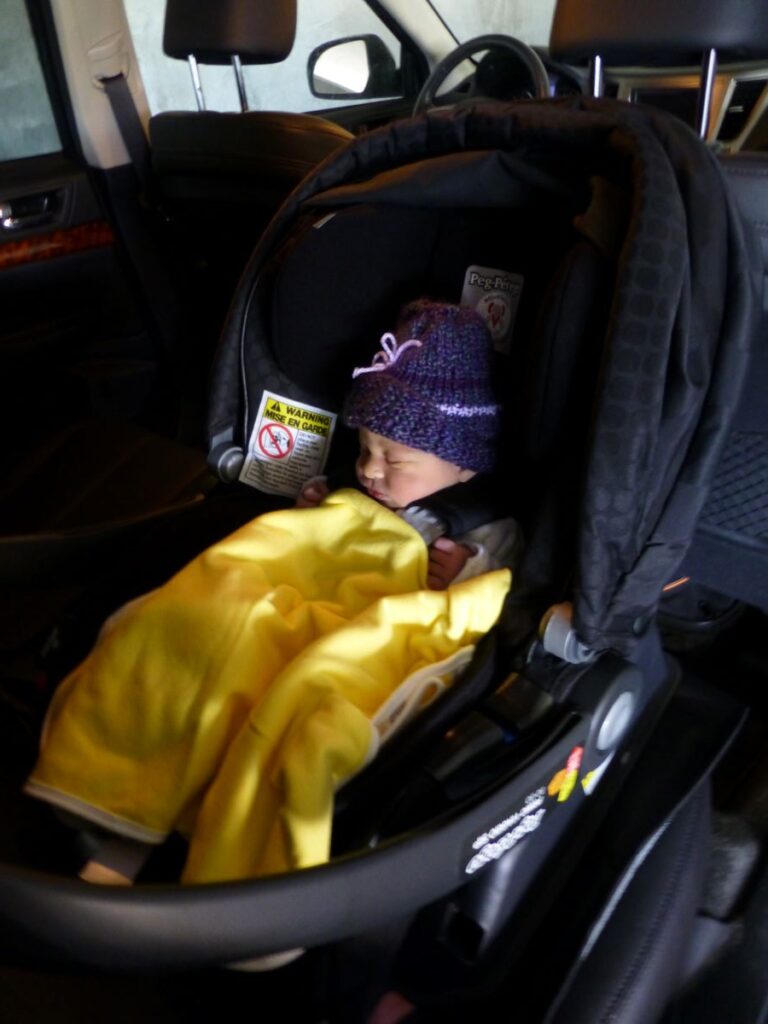 a sleeping infant on a road trip.