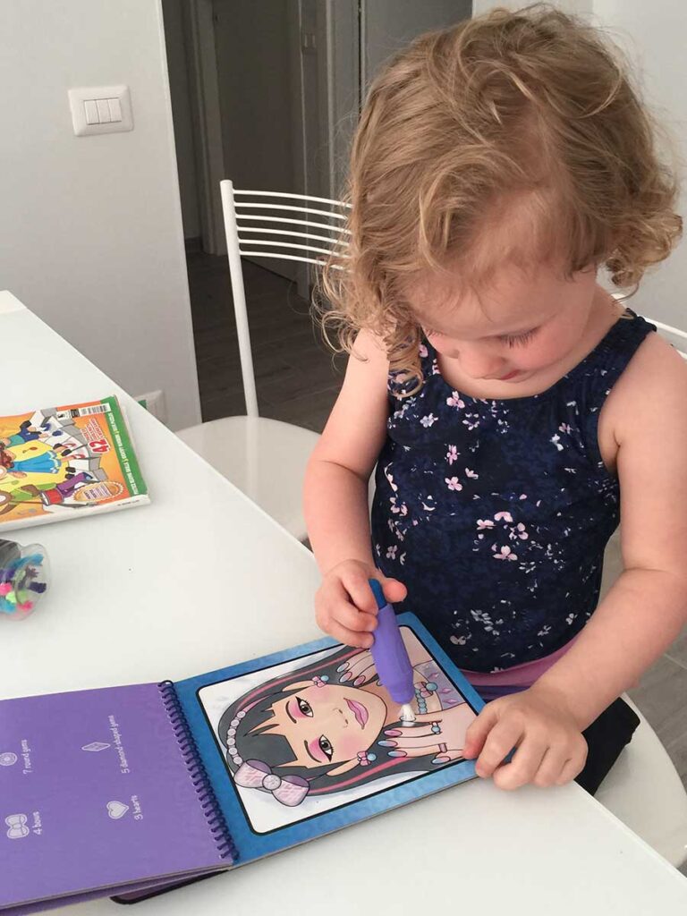 toddler coloring in Water Wow screen free travel toy.