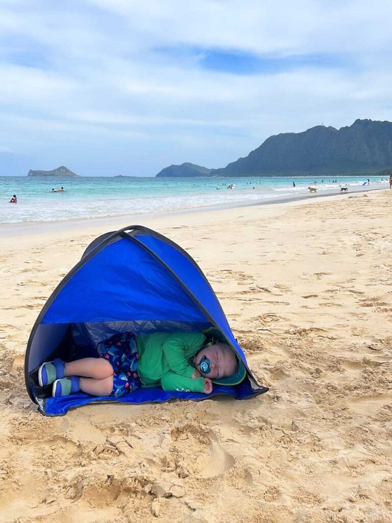 toddler using beach tent