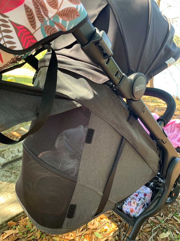 Stroller's peek-a-boo window, showing baby sleeping. 