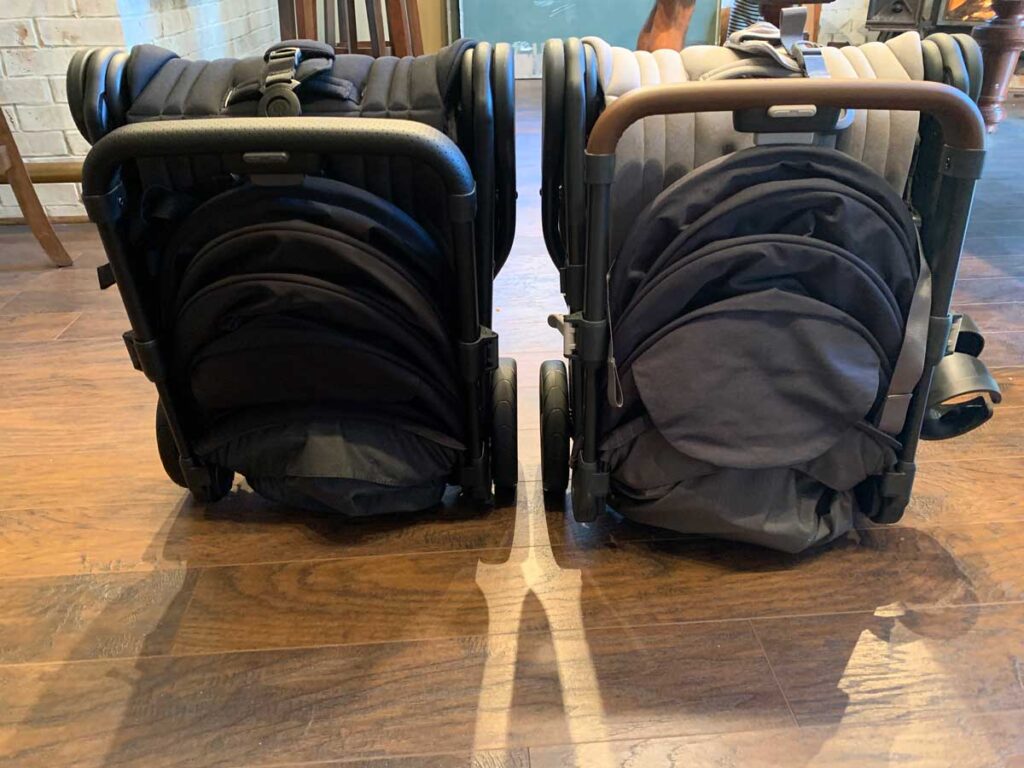 2 strollers folded up side by side. 