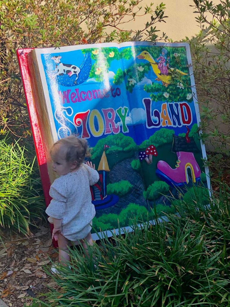 Baby in front of story book.