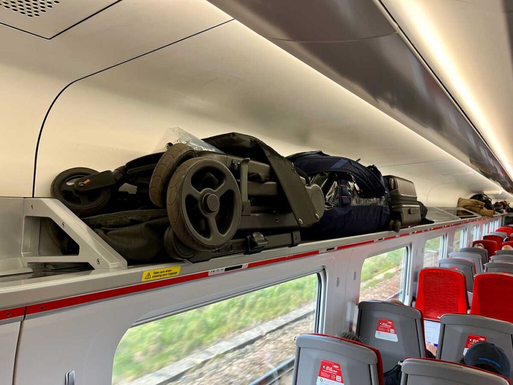 ErgoBaby Metro+ Stroller used on train and storing on overhead rack.