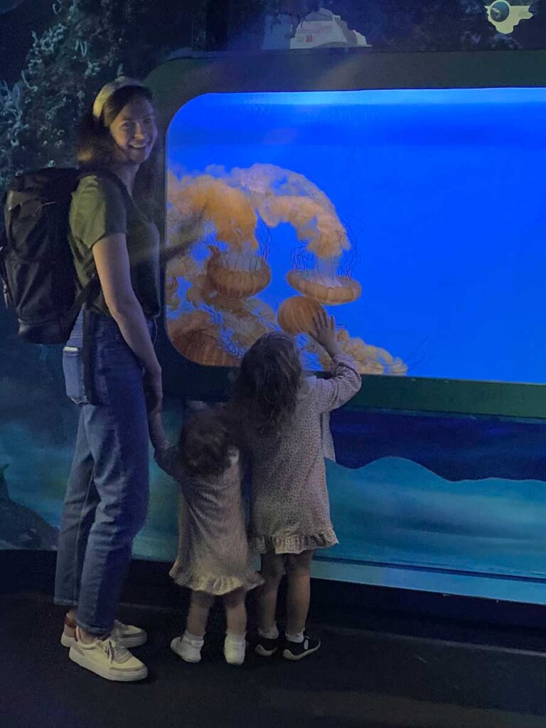 Mom and daughter at an aquarium. 