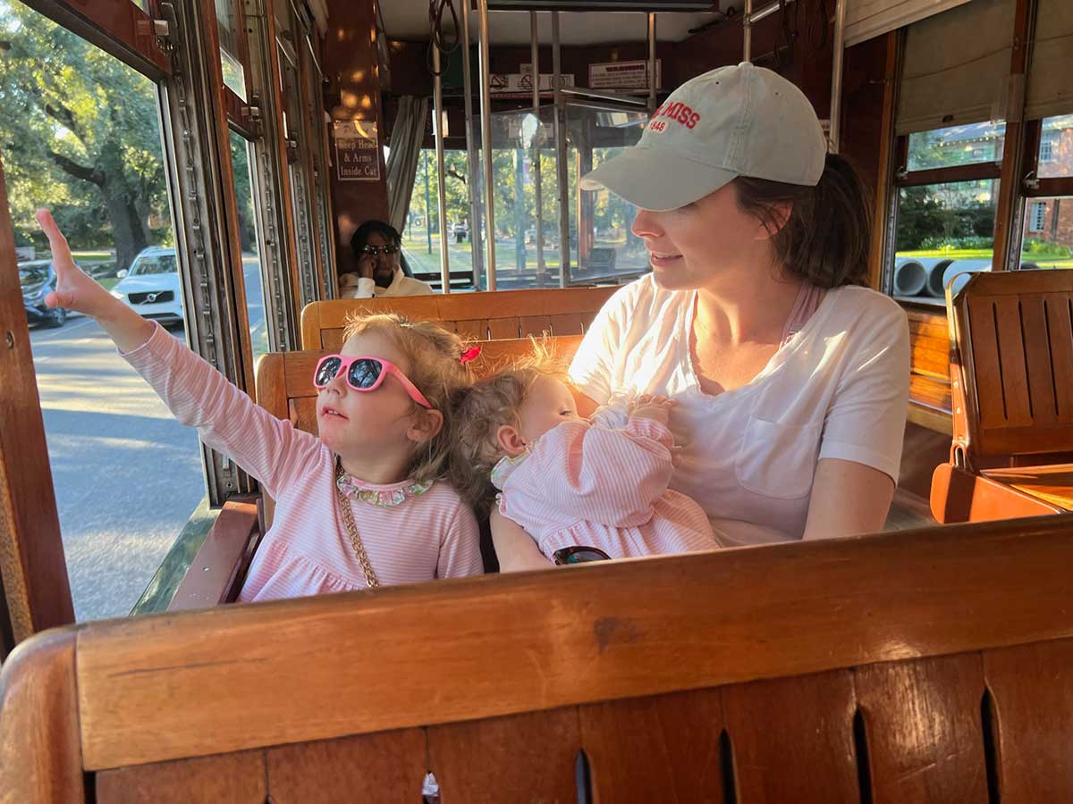 mom and daughters on streetcar.