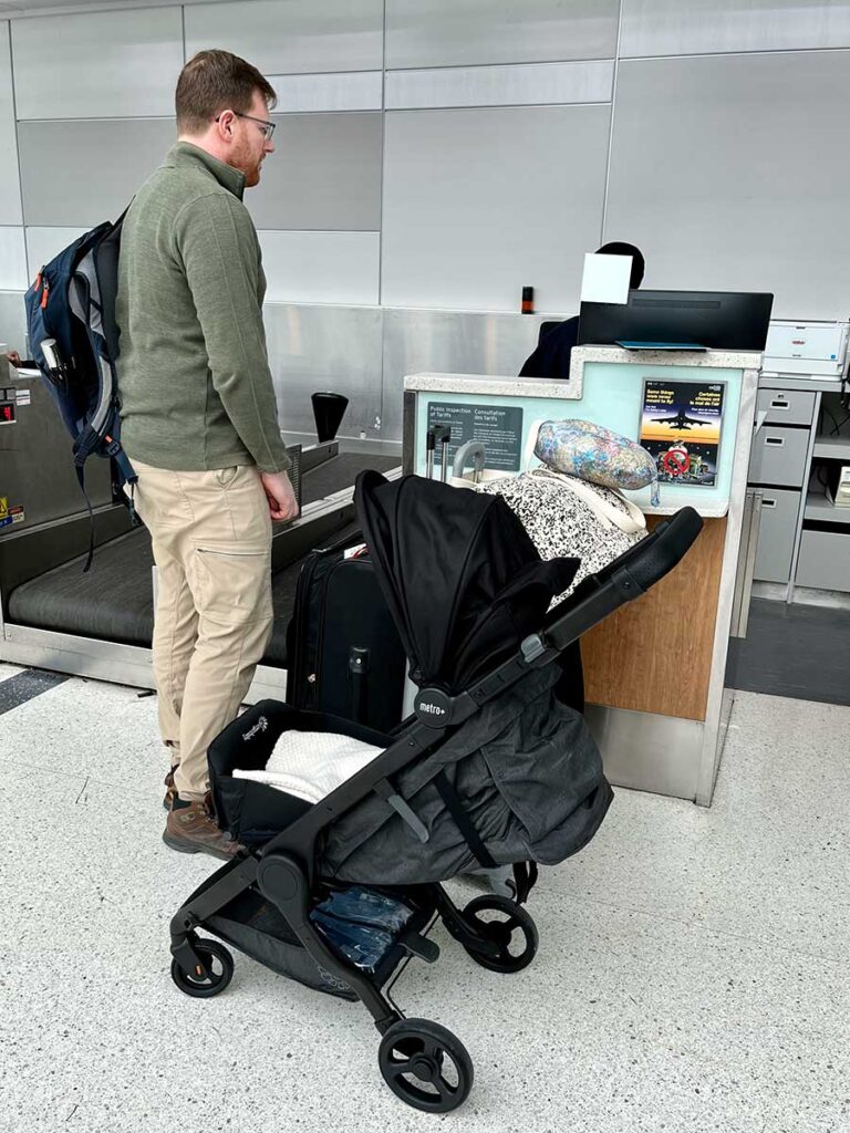 Using ErgoBaby Metro+ travel stroller at airport.