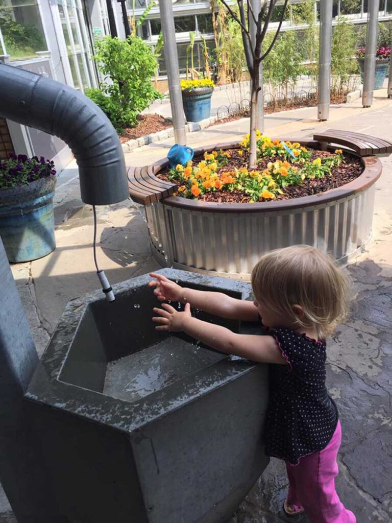 young girl playing in water.