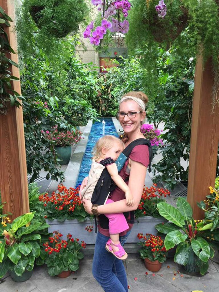 Mom and girls in front of botanic garden.