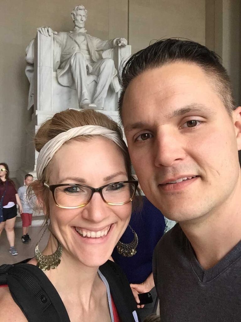 couple standing in front of Lincoln memorial.