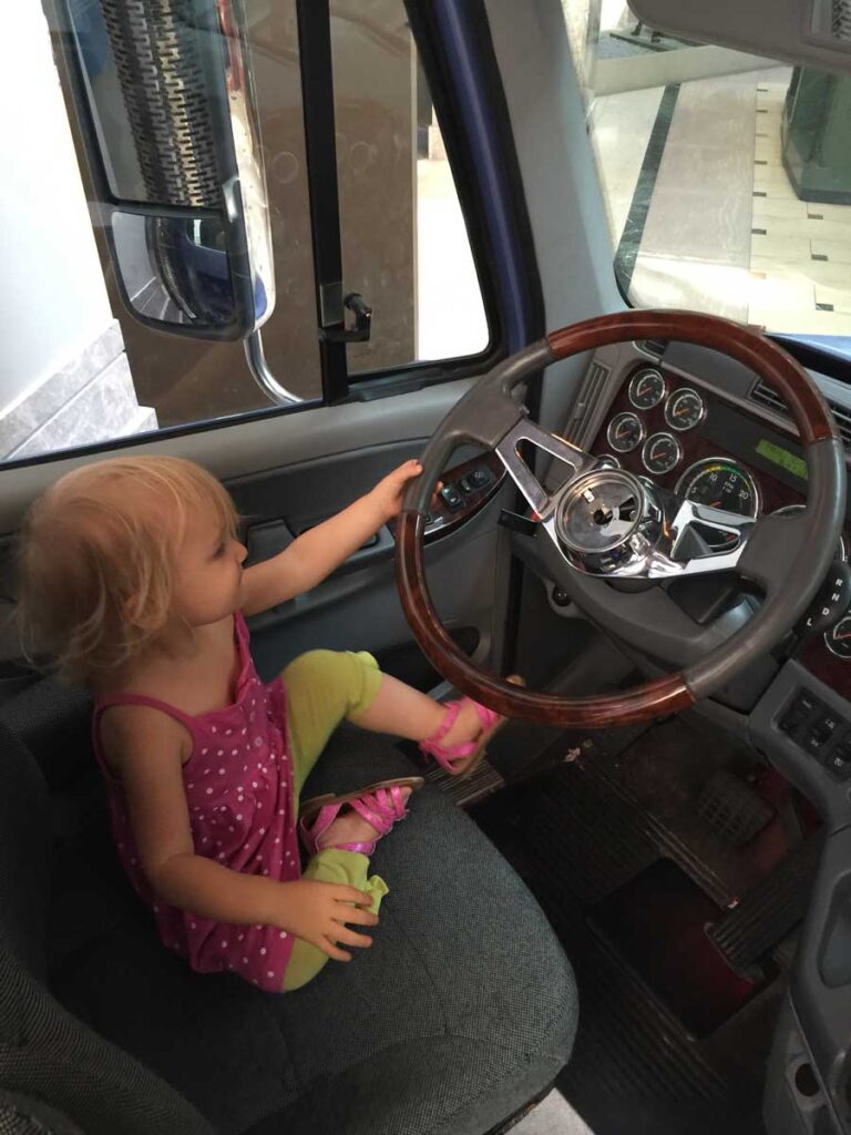 young girl playing in postal museum truck.