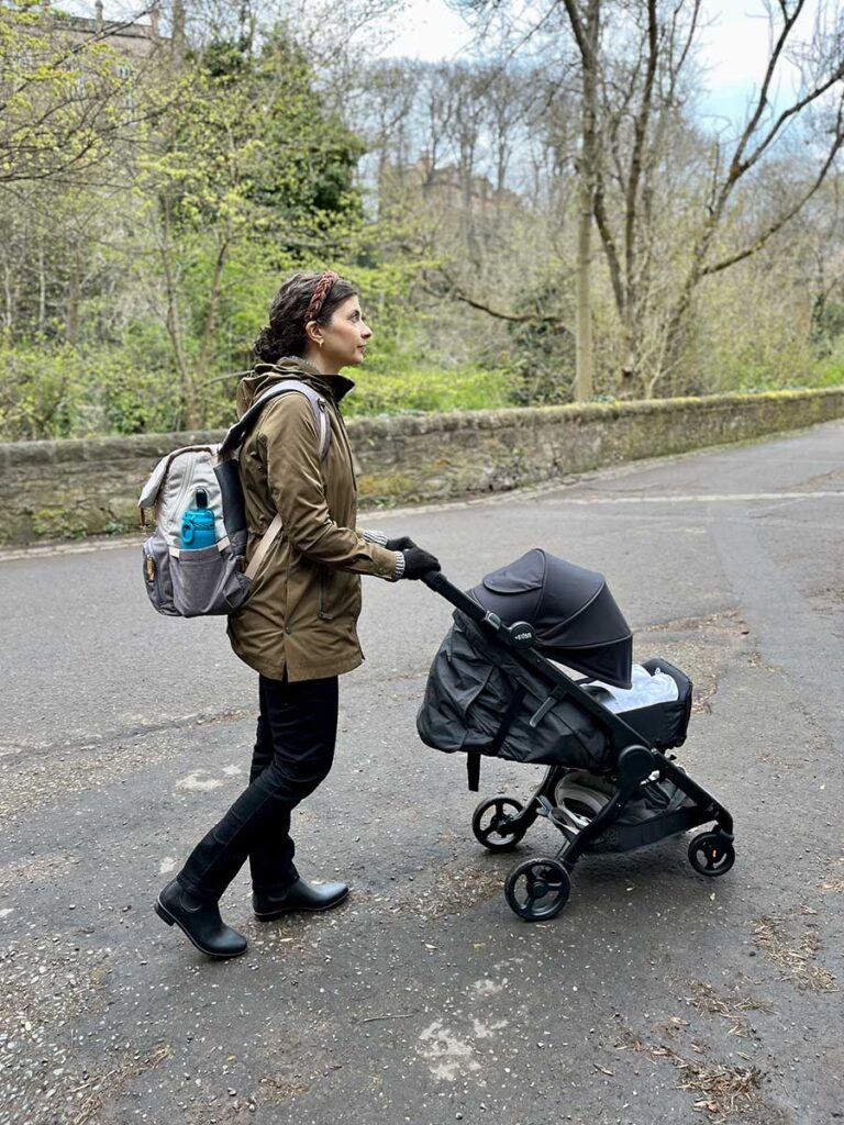 Woman pushing stroller - travel with ErgoBaby Metro+ Stroller.