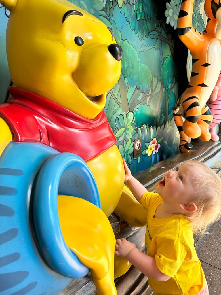 Baby with Winnie the Pooh at Disney.