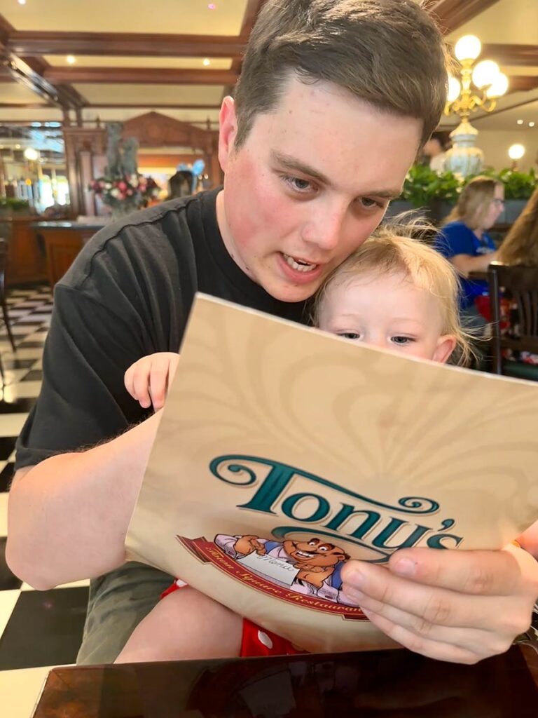 Dad looking at menu with baby at Disneyworld.