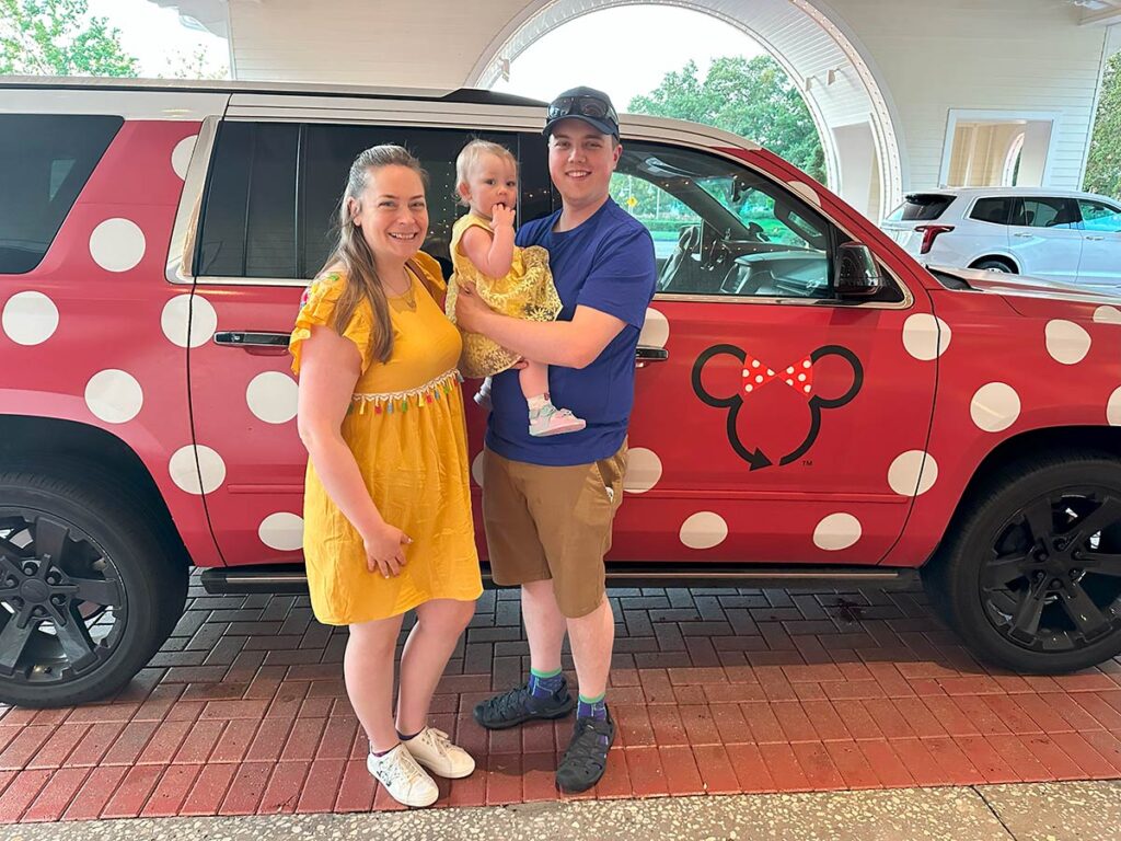 Family standing in front of Minnie Van while at Disney World.