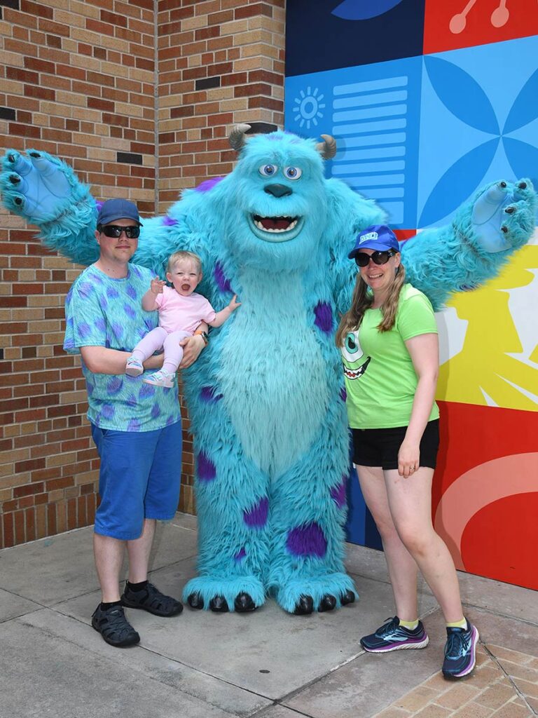 Family posing for photo with Sully.