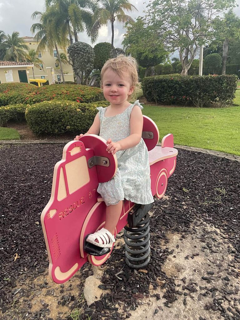 Toddler playing on a spring ride at playground in San Juan, Puerto Rico.