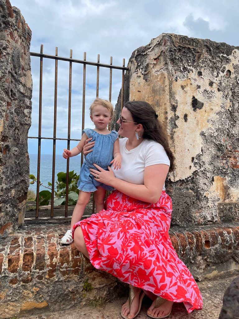 Woman and baby posing for a photo in front of a gate in San Juan, Puerto Rico.