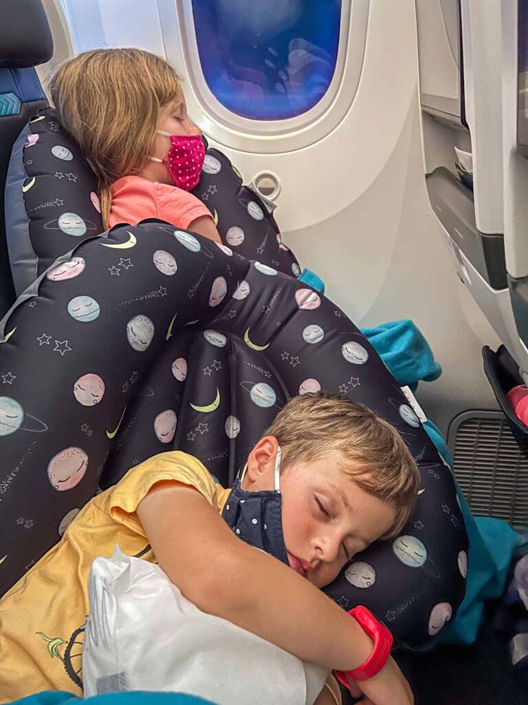 The Brewer kids sleep on an airplane with the help of a Seat to Sleep Travel Nest.